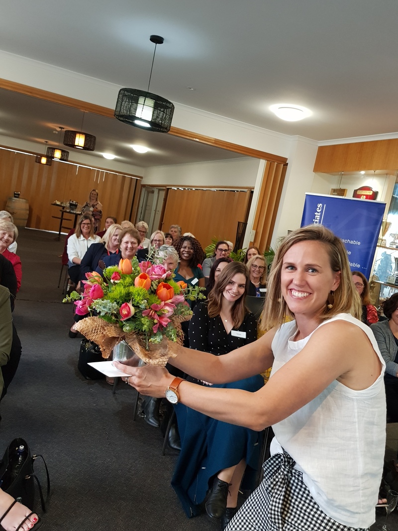 Krisit Van Es holds flowers at the Patrick Rowan Ladies Charity Luncheon